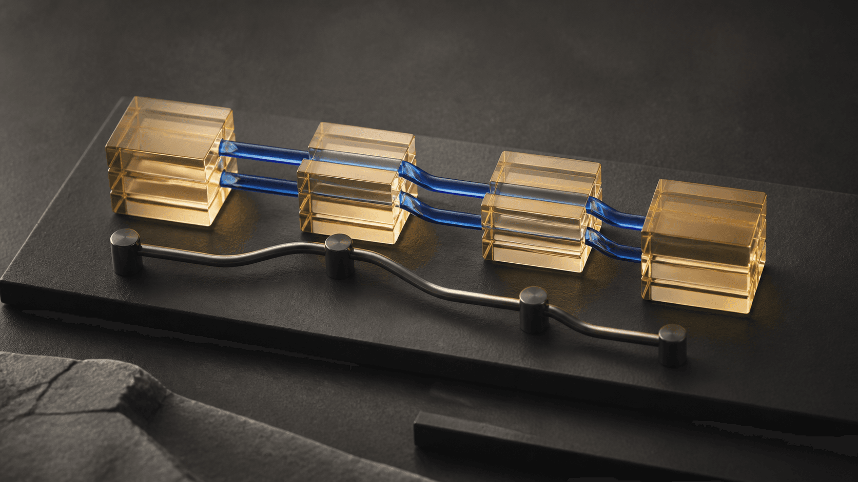 Warm-gold glass chord blocks joined by close blue note paths and an independent bass line on a graphite composition table.